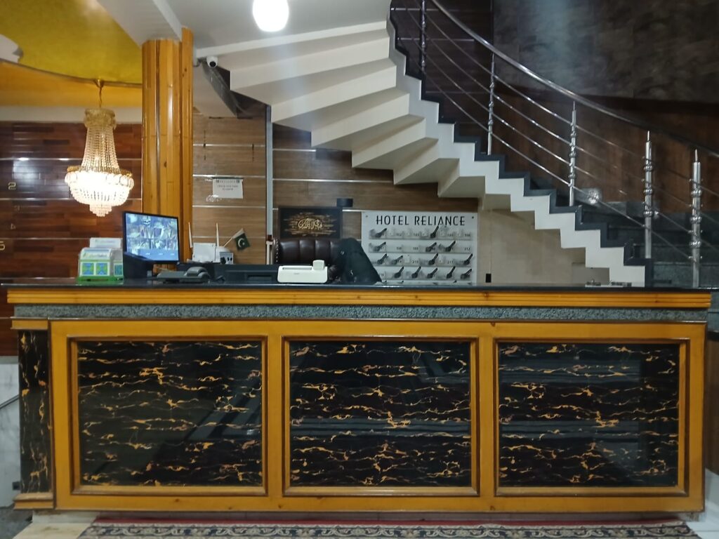Reception area of Reliance Hotel Quetta with welcoming staff and modern décor